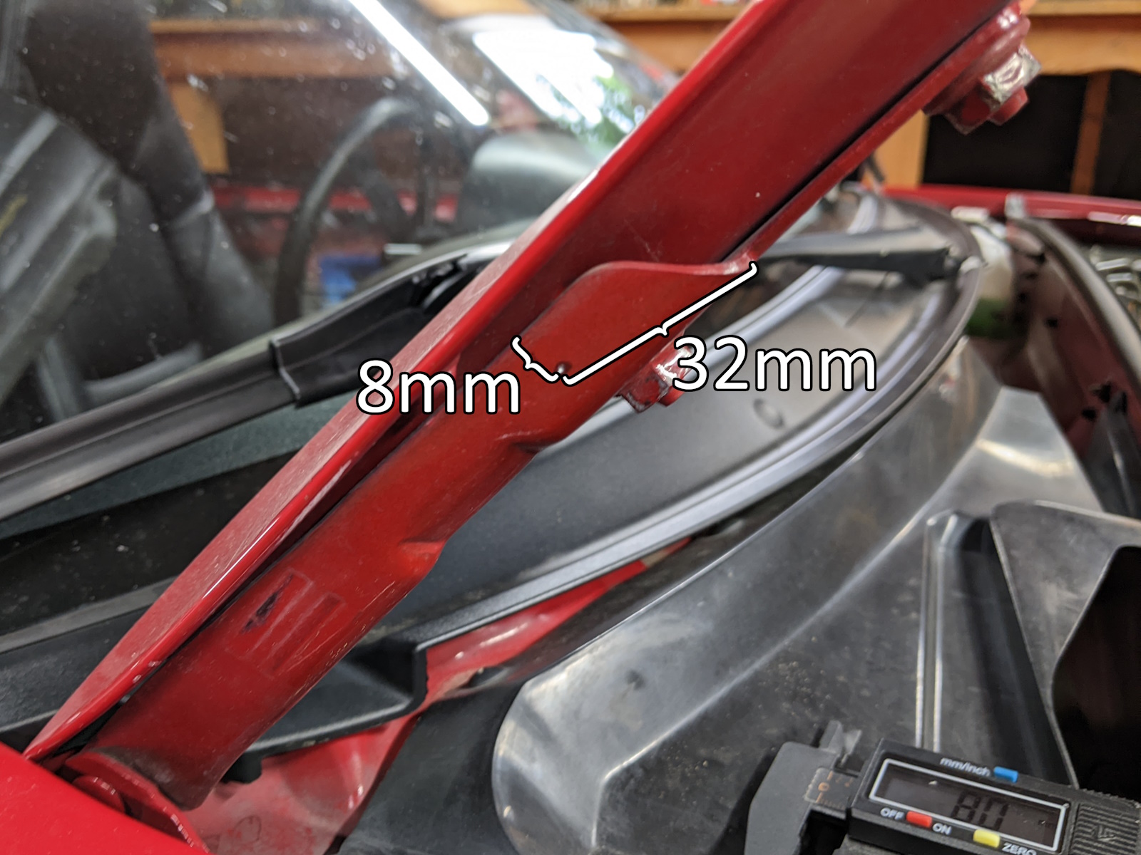 Strut mount drill location on hood support hinge